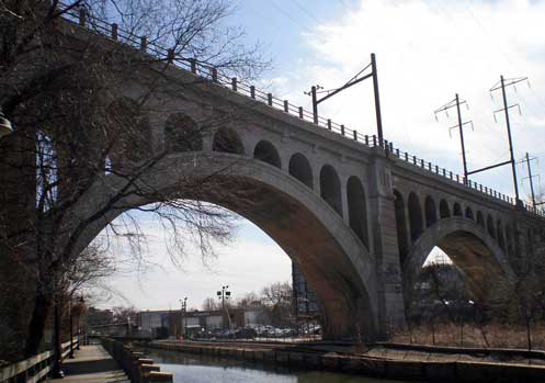 Figure 4 is the arch bridge as seen today. This bridge replaced the original bridge in 1918. SEPTA no longer uses the bridge and plans are underway to use it as a bike and hiking trail connecting the suburbs to the existing bike trail that runs from Manayunk to Valley Forge. A web site with an amazing set of photographs from a post card collection is linked below which shows the original’s bridge (last checked in June, 2011). http://maggieblanck.com/Land/Philly.html