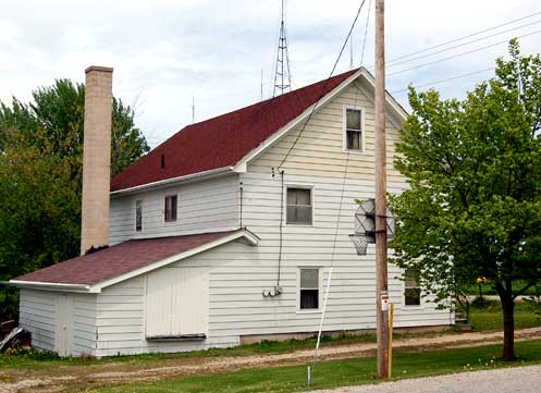 Figure 9. Former cheese factory in Town of Eldorado, Fond du Lac County, now being used as a residence. The large chimney and milk can loading dock are clues to this structures former use. Note the similarities with Figure 4, which displays the ramp that is currently used to load and unload milk cans at its loading dock.