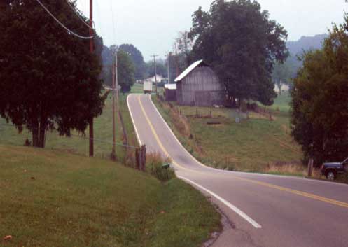 Figure 2. U.S. Highway 321 winds through Greene County before construction transformed the roadway. The narrow old road extended commute times while several notorious sharp curves were common accident locations. Photo by author, 2001.